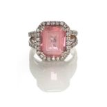 A TOURMALINE AND DIAMOND RING claw set to the centre with an emerald-cut pink tourmaline weighing