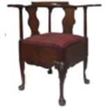 A MAHOGANY CORNER ARMCHAIR, 19TH CENTURY the curved and shaped backrail supported by three turned