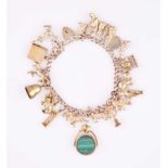A CHARM BRACELET the curb-link chain with padlock clasp, impressed 9ct, suspending various charms