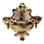 A CHINESE CARVED JADE TWO-HANDED TRIPOD KORO AND COVER the compressed globular body with dragon
