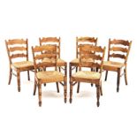 A SET OF SIX FRUITWOOD LADDERBACK SIDE CHAIRS each shaped ladderback between turned supports