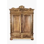 A GERMAN OAK BODENSEE SCHRANK, 19TH CENTURY the shaped pediment centred by a shell cresting above