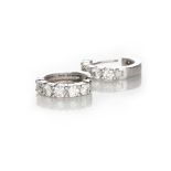A PAIR OF DIAMOND EARRINGS each designed as a hinged hoop, claw set to the front with brilliant-