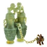 A PAIR OF CHINESE CARVED JADE CONJOINED TWO-HANDLED VASES AND COVERS each tapering body carved