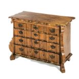 A CONTINENTAL WALNUT LOW CHEST OF DRAWERS, 19TH CENTURY the shaped moulded rectangular top above