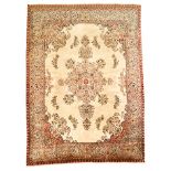 A TABRIZ CARPET, NORTH WEST PERSIA, MODERN the ivory field with a floral pale green medallion,