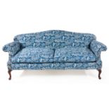A GEORGE III MAHOGANY AND UPHOLSTERED SETTEE the shaped padded back and sides upholstered in