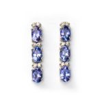 A PAIR OF TANZANITE AND DIAMOND EARRINGS each designed as an articulated line of oval mixed-cut