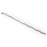 A DIAMOND BRACELET composed of a series of links of intertwined scroll design alternating with