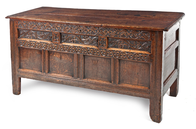 A JAMES I CARVED OAK COFFER the hinged moulded rectangular top enclosing a compartment, foliate-