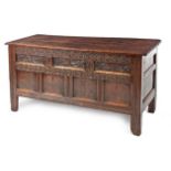 A JAMES I CARVED OAK COFFER the hinged moulded rectangular top enclosing a compartment, foliate-