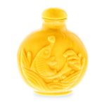 A CHINESE OPAQUE YELLOW GLASS SNUFF BOTTLE the flattened globular body decorated in low relief