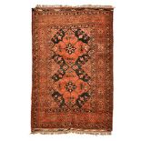 AN AFGHAN RUG, MODERN the black field with two red diamond medallions within a red rosette border,