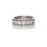 A DIAMOND RING claw set to the centre with a row of brilliant-cut diamonds, gently graduated in