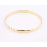 A 9CT GOLD BANGLE designed as a plain hoop with half-round profile, impressed 9ct inner diameter