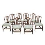 A SET OF EIGHT MAHOGANY DINING CHAIRS, 20TH CENTURY comprising: a pair of carvers and six side