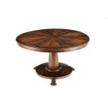 A WILLIAM IV ROSEWOOD CENTRE TABLE the radiating-veneered top above a plain frieze, on a faceted