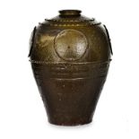 A CHINESE BROWN-GLAZED STONEWARE STORAGE JAR, 20TH CENTURY the tapering ovoid body applied with four
