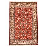 AN ISPAHAN CARPET, PERSIA, MODERN the red field with an overall design of multicoloured scrolling