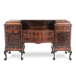 A VICTORIAN MAHOGANY PEDESTAL SIDEBOARD the serpentine top beneath a carved panelled back gallery