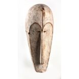 A FANG MASK the white painted elongated mask with curved forehead,slit eyes, arched eyebrows and