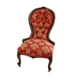 A VICTORIAN WALNUT GRANDMOTHER CHAIR the curved button-back within a conforming frame centred by a