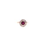 A RUBY AND DIAMOND RING centred with a circular mixed-cut ruby weighing approximately 1.29cts,