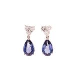 A PAIR OF TANZANITE AND DIAMOND PENDENT EARRINGS each of articulated design, the surmount