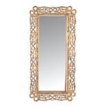 A CONTINENTAL STYLE GILT-METAL MIRROR, 20TH CENTURY the rectangular plate within a reed-and-