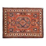 AN AFGHAN RUG, MODERN the madder-red field with a large blue octagon gul, all with bold floral