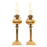 A PAIR OF CORINTHIAN COLUMN BRASS OIL LAMPS, EARLY 20TH CENTURY with brass reservoir, on a