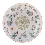 A CHINESE FAMILLE VERT DISH, LATE 19TH CENTURY painted with a central green floral motif within a