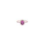 A PINK SAPPHIRE AND DIAMOND RING centred with an oval mixed-cut pink sapphire weighing approximately