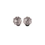 A PAIR OF 9CT WHITE GOLD AND DIAMOND EAR STUDS each designed as a stylised flower embellished with