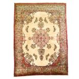 A TABRIZ CARPET, NORTH WEST PERSIA, MODERN the ivory field with a floral pale green medallion,