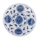 A CHINESE BLUE AND WHITE PLATE decorated with lotus surrounding a central rondel, six character
