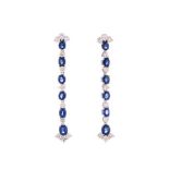 A PAIR OF SAPPHIRE AND DIAMOND PENDENT EARRINGS each designed as an articulated line of oval mixed-