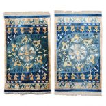 A PAIR OF CHINESE SILK RUGS, MODERN the blue field with a round medallion, all depicting birds,
