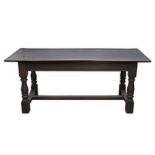 AN OAK REFECTORY TABLE the rectangular top above a plain frieze, on baluster-turned legs joined by