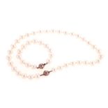 A SHELL PEARL NECKLACE composed of thirty-three shell pearls measuring approximately 12mm in
