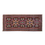 A NORTH-WEST PERSIAN CARPET, MODERN the black field with five stylised floral medallions depicted in