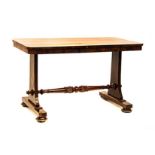 A VICTORIAN ROSEWOOD WRITING TABLE the rectangular top above a plain frieze, on shaped stile