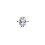 AN AQUAMARINE AND DIAMOND RING centred with an oval mixed-cut aquamarine weighing approximately 3.