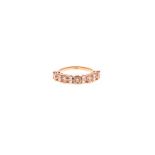 A DIAMOND HALF-ETERNITY RING claw-set to the centre with eight cognac-coloured round brilliant-cut