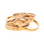 A SET OF SEVEN 9CT GOLD BANGLES each of plain form, various thicknesses, impressed 9ct, inner