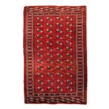 A YAMUT TURKOMAN CARPET, NORTHERN PERSIA, CIRCA 1950 the red field with four rows of twelve guls and