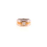 A DIAMOND RING, BROWNS the broad two tone band bezel-set to the centre with four princess-cut