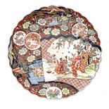 A JAPANESE IMARI CHARGER. MEIJI, 1868-1912 painted with five geisha wearing colourful kimonos within