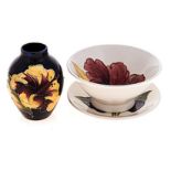 A GROUP OF THREE MOORCROFT WARES, 20TH CENTURY comprising: a ‘Hibiscus’ pattern dish, a small ‘