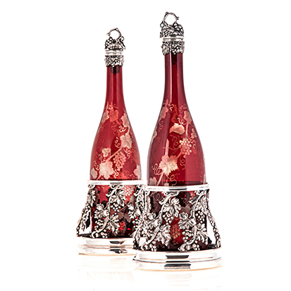 A SHEFFIELD PLATE-MOUNTED BOHEMIAN CRANBERRY GLASS DECANTER AND COASTER SET, 19TH CENTURY each